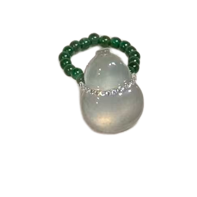 Green beaded ring with a white stone on a white background